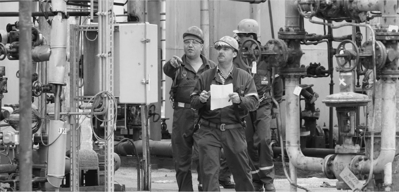 Maintenance team conducting equipment inspection at an industrial plant – representing proactive strategies to reduce maintenance costs on reliabilityacademy.com.