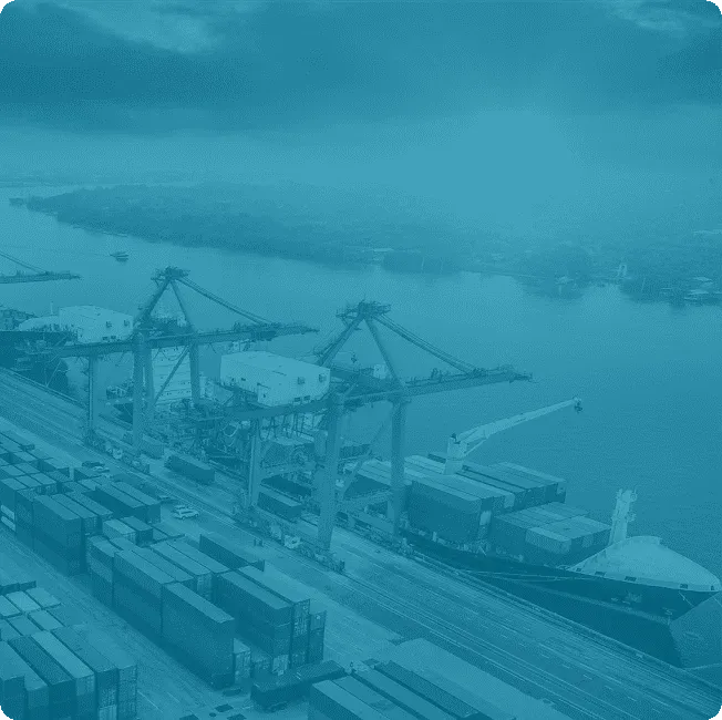 Container terminal with cranes and cargo ships—representing asset-intensive industries served by Reliability Academy’s maintenance and reliability training