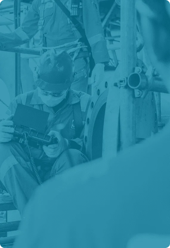 Industrial maintenance technician using diagnostic equipment during inspection—visual used in Reliability Academy training for asset-intensive industries