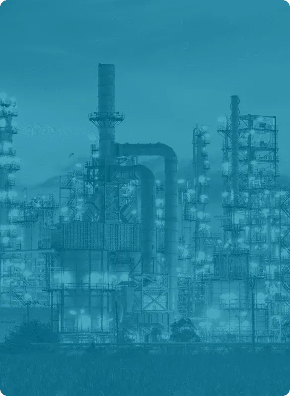 Illuminated oil and gas refinery plant at night—representing asset-intensive industry served by Reliability Academy’s maintenance and reliability training programmes