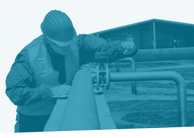 Technician inspecting industrial pipeline for defects—used in Reliability Academy’s DE100 course on foundational defect elimination practices in maintenance