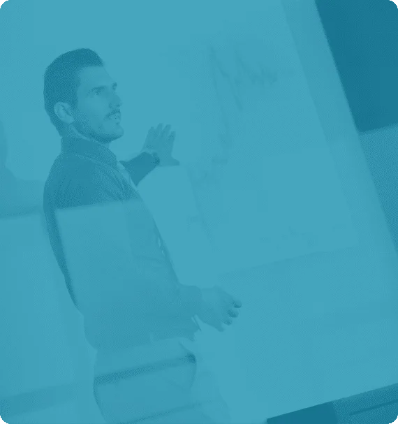 Instructor presenting reliability data on a whiteboard—used in Reliability Academy’s maintenance training to explain performance trends and root cause analysis