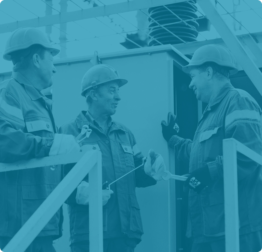 Three experienced maintenance technicians collaborating on site—visual used by Reliability Academy to convey understanding of frontline realities in asset-intensive industries